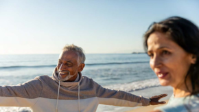 Couple exercising on a sunny beach